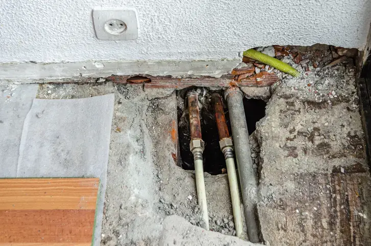 Floor opened down through the slab to reach leaking copper pipes in a La Habra home