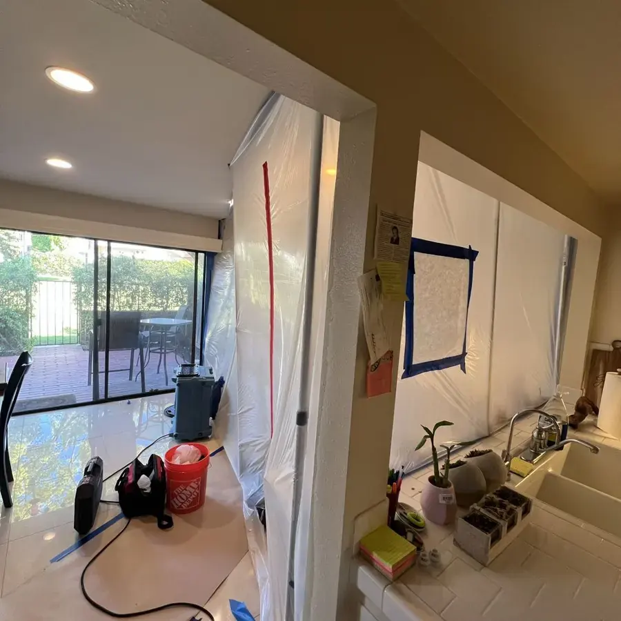 Containment plastic and drying equipment set up in a La Habra kitchen and dining area